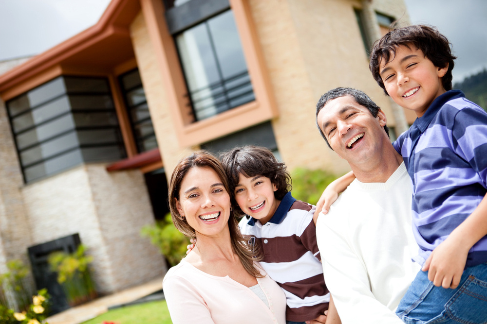 Beautiful family portrait smiling outside their new house