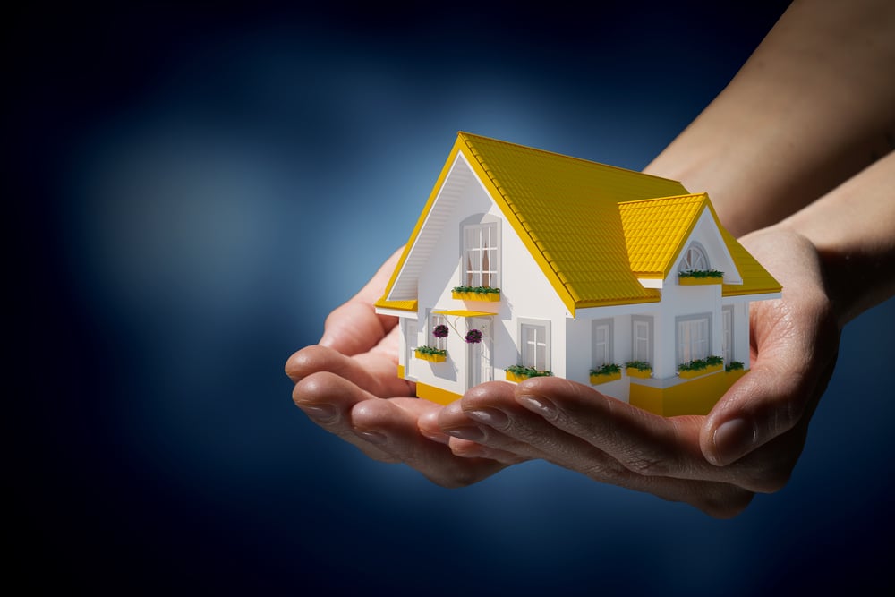 Human hands holding model of dream house-2